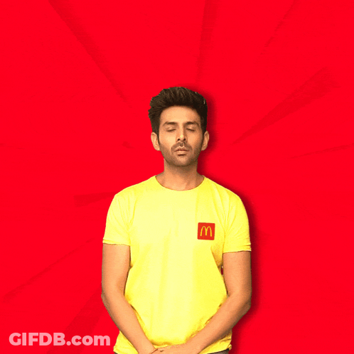 A Man Wearing A Yellow Shirt With A Mcdonald 'S Logo On It Says Let 'S Go Eat GIF