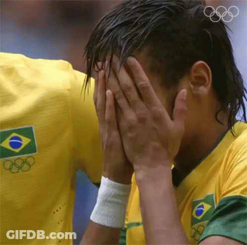 A Man Wearing A Yellow Shirt With The Olympic Rings On It GIF