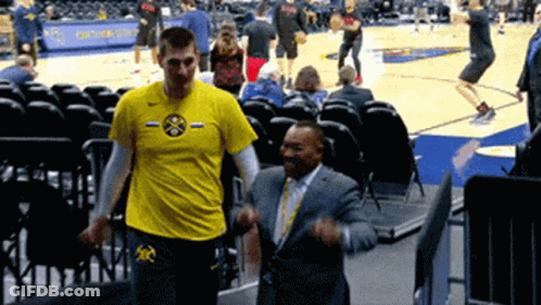 A Man Wearing A Yellow Shirt With The Word Denver On It GIF