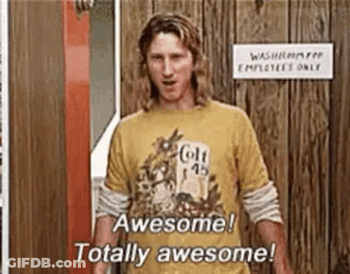 A Man Wearing A Yellow T-Shirt Is Standing In Front Of A Wooden Door . GIF