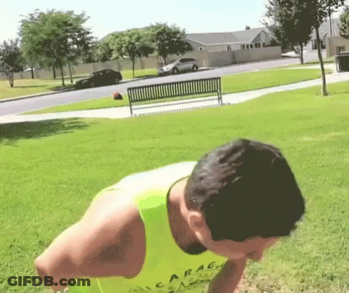 A Man Wearing A Yellow Tank Top That Says Garag On It GIF