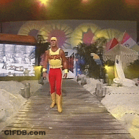 A Man Wearing A Yellow Tank Top That Says Hulk Hogan Walks Down A Wooden Ramp GIF