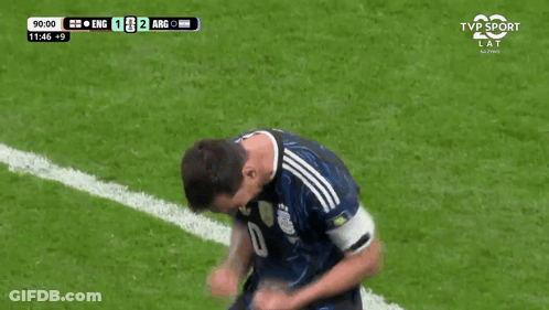 A Man Wearing A Yellow Vest With The Number 8 On It Stands On A Soccer Field GIF