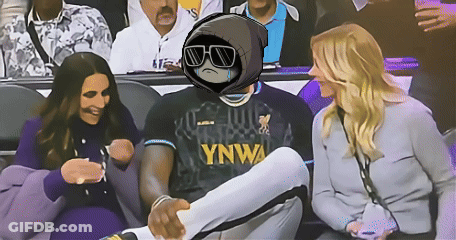 A Man Wearing A Ynwa Jersey Sits In A Crowd GIF