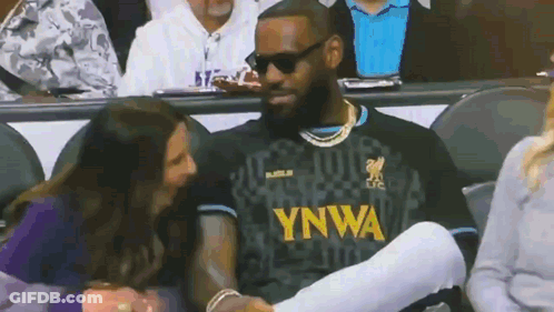 A Man Wearing A Ynwa Jersey Talks To A Woman In The Stands GIF