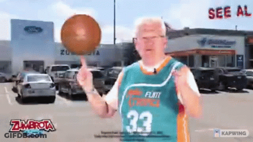 A Man Wearing A Zumbrota Jersey Is Holding A Basketball GIF