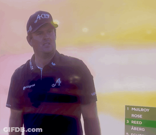 A Man Wearing An Aces Hat Stands In Front Of A Screen GIF