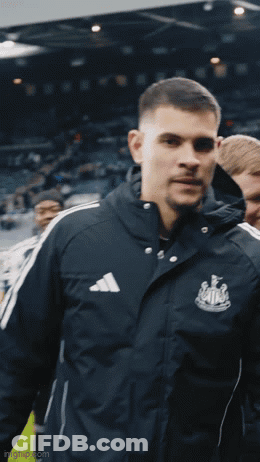A Man Wearing An Adidas Jacket Is Standing In A Crowd GIF