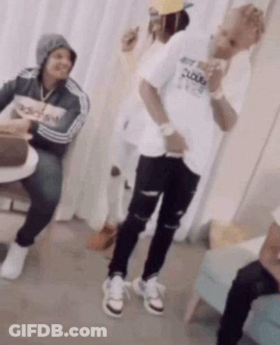 A Man Wearing An Adidas Shirt Is Dancing In A Room GIF