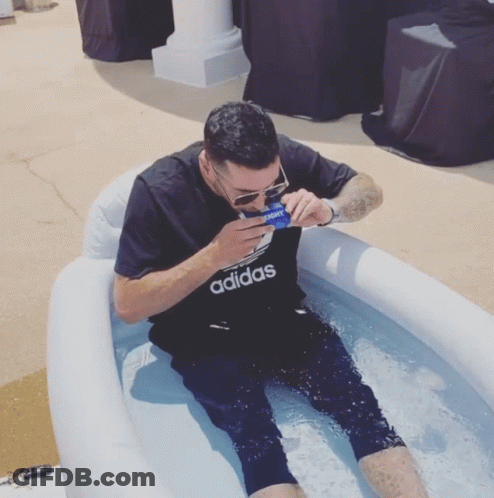 A Man Wearing An Adidas Shirt Sits In A Pool Of Water GIF