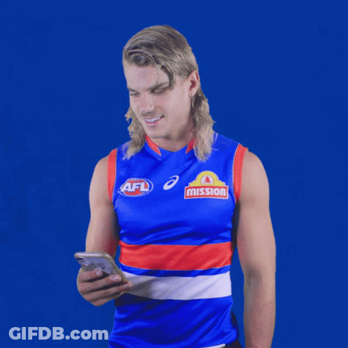 A Man Wearing An Afl Jersey Looks At A Cell Phone GIF