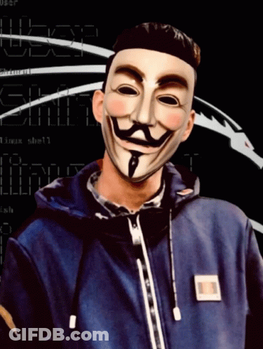 A Man Wearing An Anonymous Mask Stands In Front Of A Screen That Says ' User ' On It GIF