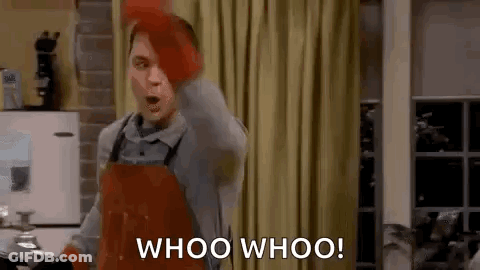 A Man Wearing An Apron And Gloves Is Standing In A Kitchen And Shouting Whoo Whoo . GIF