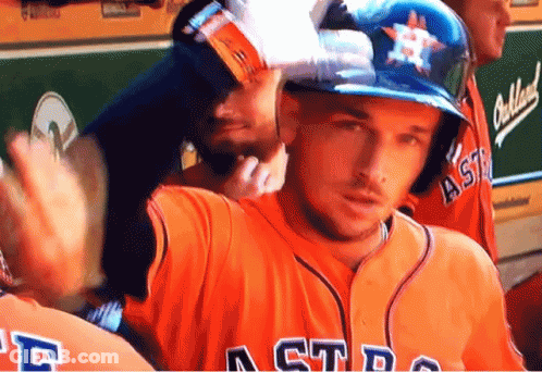 A Man Wearing An Astros Jersey Waves To Someone GIF