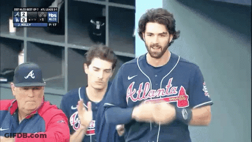 A Man Wearing An Atlanta Braves Jersey Stands In A Dugout GIF