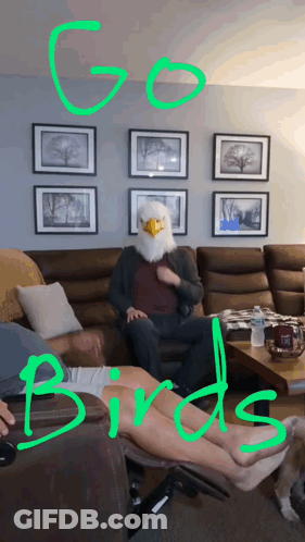 A Man Wearing An Eagle Mask Sits On A Couch With The Words Go Birds Above Him GIF