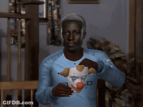 A Man Wearing An Etihad Airways Jersey Holds A Clown Mask Over His Face GIF