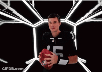 A Man Wearing An NFL Jersey Is Smiling With A Target On His Face GIF