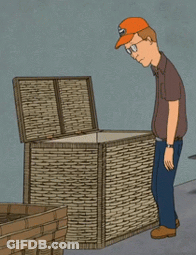 A Man Wearing An Orange Hat Is Looking Into A Wicker Box GIF