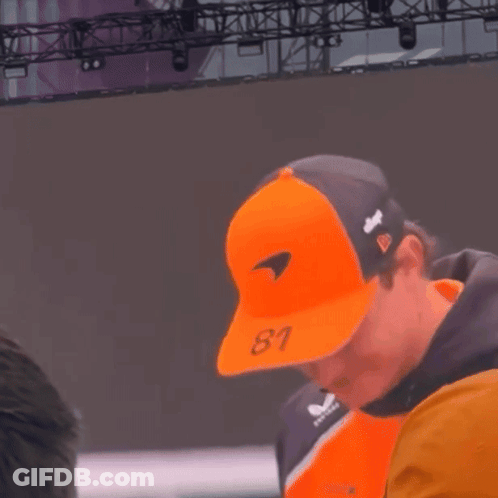 A Man Wearing An Orange Hat That Says 81 On It GIF