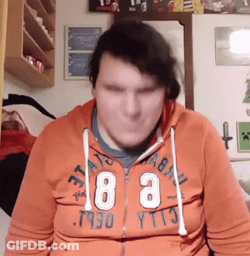 A Man Wearing An Orange Hoodie That Says ' T930 Yt13 ' On It GIF