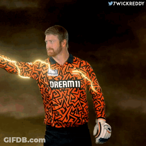 A Man Wearing An Orange Jersey That Says Dream11 On It GIF
