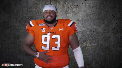 A Man Wearing An Orange Jersey With The Number 93 GIF