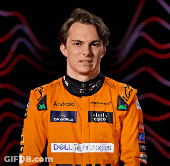 A Man Wearing An Orange Racing Suit With Dell Technologies Logos On It GIF