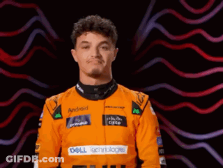 A Man Wearing An Orange Racing Suit With Dell Technologies On The Front GIF