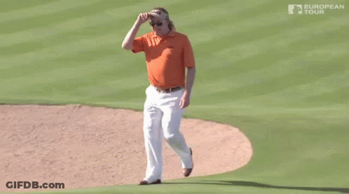 A Man Wearing An Orange Shirt And White Pants Is Walking On A Golf Course Sponsored By The European Tour GIF