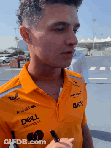A Man Wearing An Orange Shirt That Says Dell Technologies On It GIF