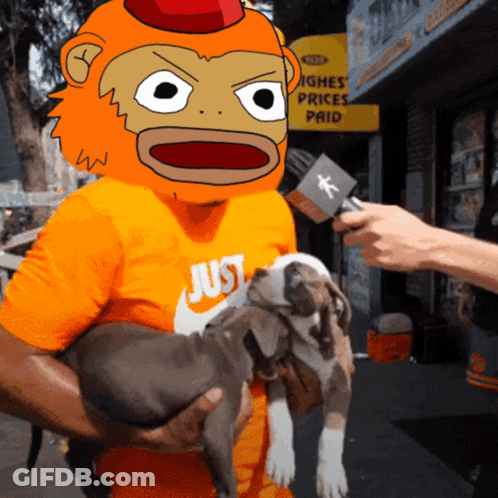 A Man Wearing An Orange Shirt That Says Just Holds A Puppy GIF