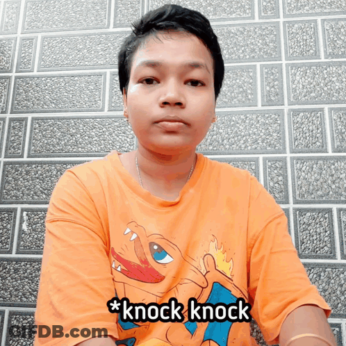 A Man Wearing An Orange Shirt That Says * Knock Knock * GIF