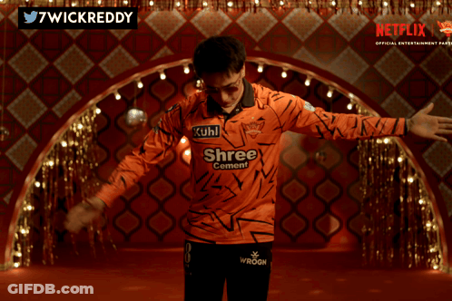 A Man Wearing An Orange Shirt That Says Kuhl Shree On It GIF