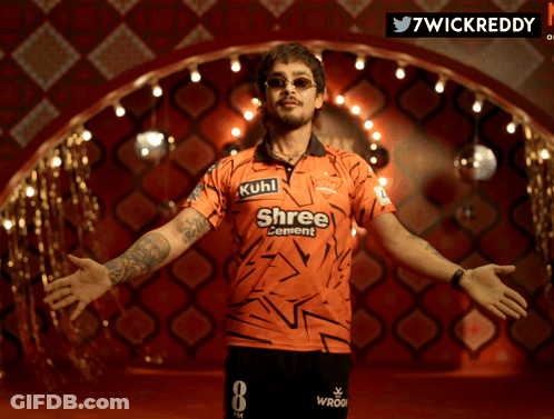 A Man Wearing An Orange Shirt That Says Shree Cement On It GIF