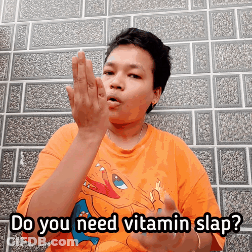 A Man Wearing An Orange Shirt With A Pokemon On It Says Do You Need Vitamin Slap GIF