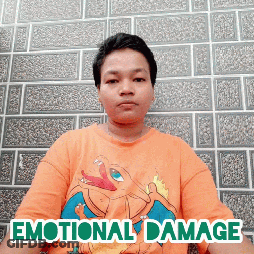 A Man Wearing An Orange Shirt With The Word Emotional Damage Written On It GIF
