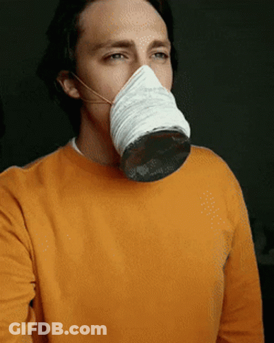 A Man Wearing An Orange Sweater And A White Mask GIF