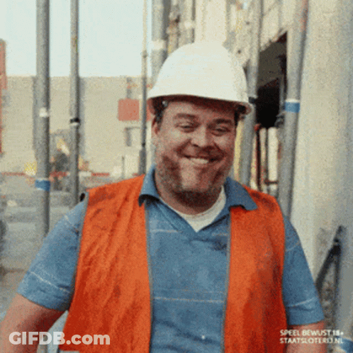 A Man Wearing An Orange Vest And Hard Hat Is Smiling GIF