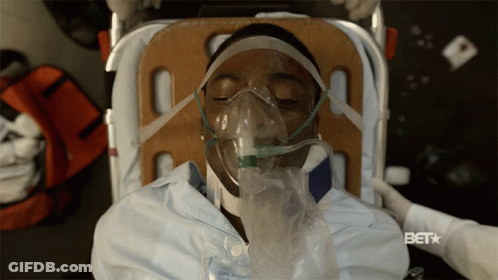 A Man Wearing An Oxygen Mask Is Laying On A Stretcher With The Bet Logo Visible GIF