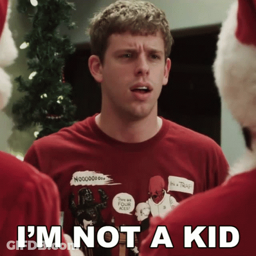 A Man Wearing An Ugly Christmas Sweater With The Words I 'M Not A Kid On The Bottom GIF