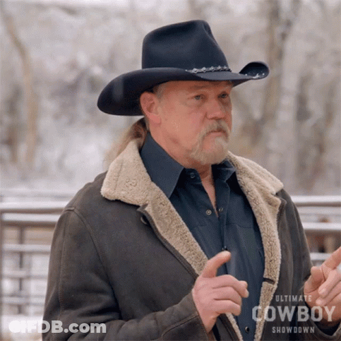 A Man Wearing An Ultimate Cowboy Showdown Jacket And Hat GIF