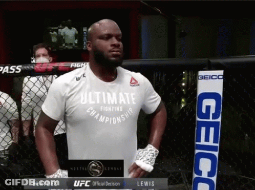 A Man Wearing An Ultimate Fighting Championship Shirt Stands In A Cage GIF