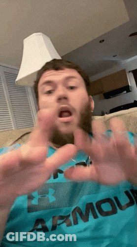 A Man Wearing An Under Armour Shirt Is Making A Funny Face GIF