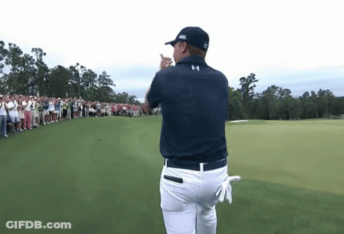A Man Wearing An Under Armour Shirt Stands On A Golf Course In Front Of A Crowd GIF