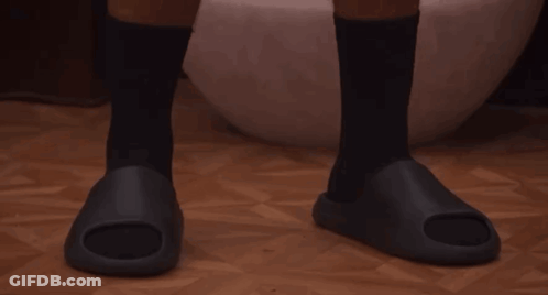 A Man Wearing Black Socks And Black Sandals GIF
