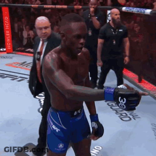 A Man Wearing Blue Shorts With The Word Ufc On The Side GIF