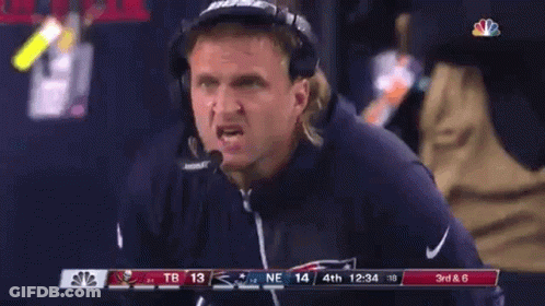 A Man Wearing Bose Headphones Is Watching A Game GIF