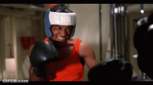 A Man Wearing Boxing Gloves And A Helmet That Says ' I ' On It GIF