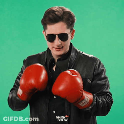 A Man Wearing Boxing Gloves And Sunglasses With The Word Heute Show On His Shirt GIF